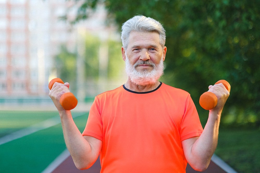 man with hand weights